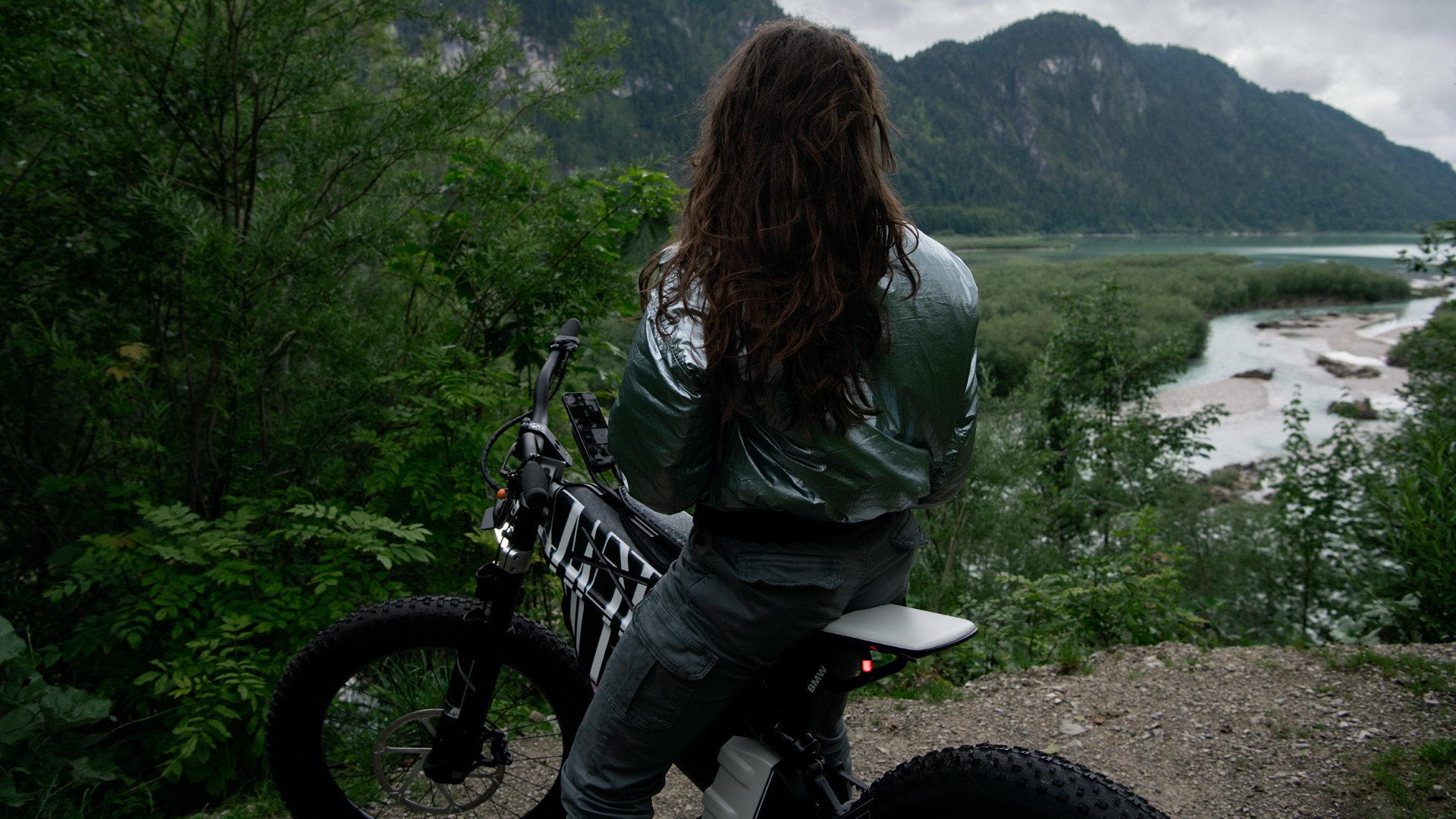 Woman sitting on Vision AMBY looking out over a mountain lake.
